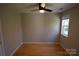 Bright bedroom with wood flooring, ceiling fan, and a window at 809 Pine Forest Rd, Charlotte, NC 28214
