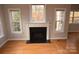 Fireplace with white mantel and granite hearth in a sunlit room at 809 Pine Forest Rd, Charlotte, NC 28214