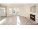 Living room with hardwood floors, fireplace and access to backyard at 8601 Sawleaf Ct, Charlotte, NC 28215