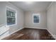 Spacious bedroom with dark hardwood floors and two windows at 1006 Rosewood Dr, Dallas, NC 28034