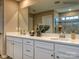 Double vanity bathroom with modern finishes and large mirror at 123 Dogwood Grove Pl, Troutman, NC 28166