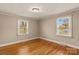 Simple bedroom with hardwood floors and two windows at 162 Jennings Rd, Statesville, NC 28625