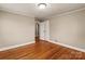 Spacious bedroom with hardwood floors and access to hallway at 162 Jennings Rd, Statesville, NC 28625