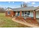 Brick ranch home with a charming front porch and landscaping at 162 Jennings Rd, Statesville, NC 28625