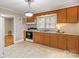 Kitchen features wood cabinets, electric range and access to laundry at 162 Jennings Rd, Statesville, NC 28625