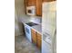 Kitchen with oak cabinets, white appliances, and a neutral countertop at 1701 Bonnie Ln, Charlotte, NC 28213