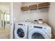 Laundry room with Whirlpool washer and dryer; shelving above at 2029 Bayou Trace Dr, Charlotte, NC 28262