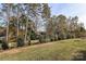 View of a grassy lot with trees and shrubs at 2029 Bayou Trace Dr, Charlotte, NC 28262