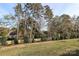 Open grassy backyard with tree line at 2101 Bayou Trace Dr, Charlotte, NC 28262