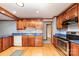 Bright kitchen with wood cabinets, blue countertops, and stainless steel appliances at 2107 Twin Ave, Gastonia, NC 28052