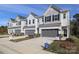 Row of townhouses with gray garage doors and front yards at 2109 Bayou Trace Dr, Charlotte, NC 28262