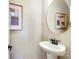 Stylish powder room with pedestal sink and round mirror at 2109 Bayou Trace Dr # Lot 11, Charlotte, NC 28262