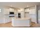 Modern kitchen with white cabinets, quartz countertops, and island at 223 Hamptons Cove Rd, Troutman, NC 28166