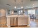 Kitchen island with sink and dishwasher, open to living area at 223 Hamptons Cove Rd, Troutman, NC 28166