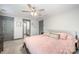 Main bedroom with pink bedding, ceiling fan, and ensuite bathroom at 305 Piedmont Ave, Mount Holly, NC 28120