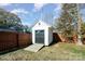 White shed with dark gray doors and wood ramp at 305 Piedmont Ave, Mount Holly, NC 28120