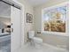 Bathroom with sliding barn door and window at 335 Eastcliff Se Dr, Concord, NC 28025