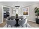 Modern dining room with a round table and chairs, offering kitchen views at 335 Eastcliff Se Dr, Concord, NC 28025