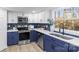 Updated kitchen featuring white and navy blue cabinets and stainless steel appliances at 335 Eastcliff Se Dr, Concord, NC 28025