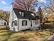 Renovated white house with black accents, showcasing curb appeal and landscaping at 425 N 5Th St, Albemarle, NC 28001