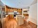 Kitchen with oak cabinets, island, stainless steel appliances, and hardwood floors at 4761 Sand Clay Rd, Hickory, NC 28602