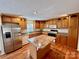 Kitchen with oak cabinets, island, stainless steel appliances, and hardwood floors at 4761 Sand Clay Rd, Hickory, NC 28602