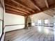 Living room with hardwood floors, stone fireplace, and exposed beams at 5407 Davis Rd, Waxhaw, NC 28173