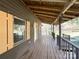 Spacious front porch with wooden railings and string lights at 5407 Davis Rd, Waxhaw, NC 28173