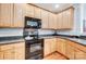 Modern kitchen features dark countertops and light wood cabinets at 6412 Park Pond Dr, Charlotte, NC 28262