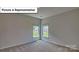 Bright bedroom with corner windows and carpet flooring at 8030 Kennesaw Dr, Gastonia, NC 28056