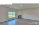 Living room with a corner fireplace and large window at 8030 Kennesaw Dr, Gastonia, NC 28056