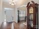 Foyer with hardwood floors, grandfather clock, and access to a dining area at 8322 Curico Ln, Charlotte, NC 28227