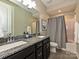 Double vanity bathroom with granite countertop, shower/tub combo, and gray tile floor at 946 Emory Ln, Fort Mill, SC 29708