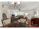 Open dining area with glass-top table and chairs, adjacent to the living room at 12869 Spirit Bound Way, Charlotte, NC 28273