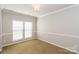 Well-lit bedroom with neutral walls and carpet at 13104 Serenity St, Huntersville, NC 28078