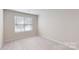 Well-lit bedroom featuring neutral walls and carpeted floors at 14057 Castle Nook Dr, Charlotte, NC 28273