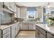 Modern kitchen with gray cabinets, white countertops, and a stylish backsplash at 1476 Hubert Graham Way, Tega Cay, SC 29708