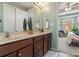 Spacious bathroom with double sinks, large mirror, and view of bedroom at 204 Planters Way, Mount Holly, NC 28120