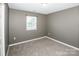 Empty bedroom featuring gray walls and neutral carpeting at 210 South Haven Dr, Mooresville, NC 28117