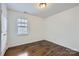 Light and airy bedroom with hardwood floors and a window at 2424 Pitts Dr, Charlotte, NC 28216