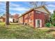 Brick house exterior showcasing a spacious backyard and additional structure at 4301 Murrayhill Rd, Charlotte, NC 28209