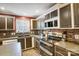 Modern kitchen with stainless steel appliances and dark brown cabinets at 4450 Dobys Bridge Rd, Fort Mill, SC 29707