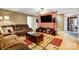 Living room with brown sectional sofa and large TV at 4450 Dobys Bridge Rd, Fort Mill, SC 29707