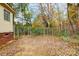 Fenced side yard with gated dog run and mature trees at 4450 Dobys Bridge Rd, Fort Mill, SC 29707