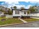 Charming white house with a gray accent, front porch, and well-maintained landscaping at 494 Washington St, Cramerton, NC 28032