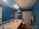 Bathroom with a double vanity, shower, and beach themed decor at 5168 Thomasville Dr, Belmont, NC 28012