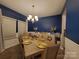 Elegant dining room with a navy blue accent wall and gold details at 5168 Thomasville Dr, Belmont, NC 28012