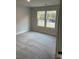 Well-lit bedroom featuring neutral walls and plush carpeting at 715 Ne Branchview Ne Dr, Concord, NC 28025