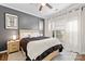 Stylish bedroom with a wooden bed frame and a gray accent wall at 9317 Meadow Vista Rd, Charlotte, NC 28213