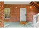 Private condo entry with brick exterior and white door at 9317 Meadow Vista Rd, Charlotte, NC 28213